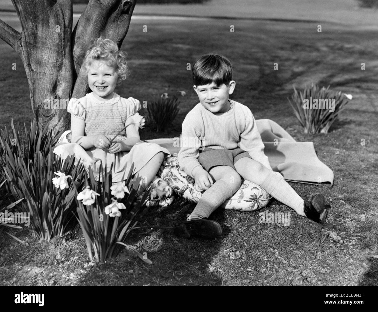 File phoo dated 22/04/54 of the Princess Royal and the Prince of Wales sitting among the daffodils in the grounds of the Royal Lodge, Windsor, Berkshire. Anne celebrates her 70th birthday on Saturday. Stock Photo