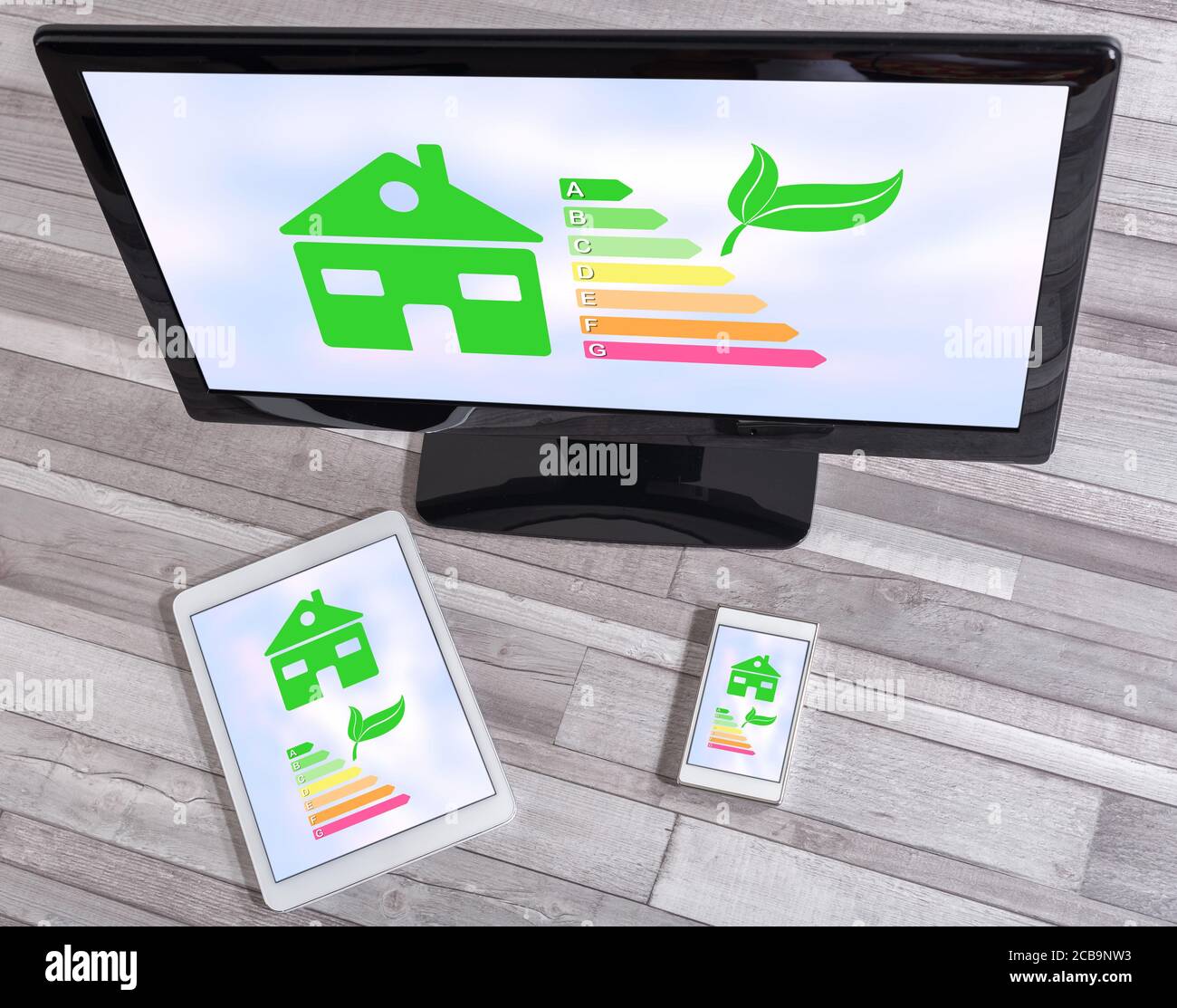 Home energy efficiency concept shown on different information technology devices Stock Photo