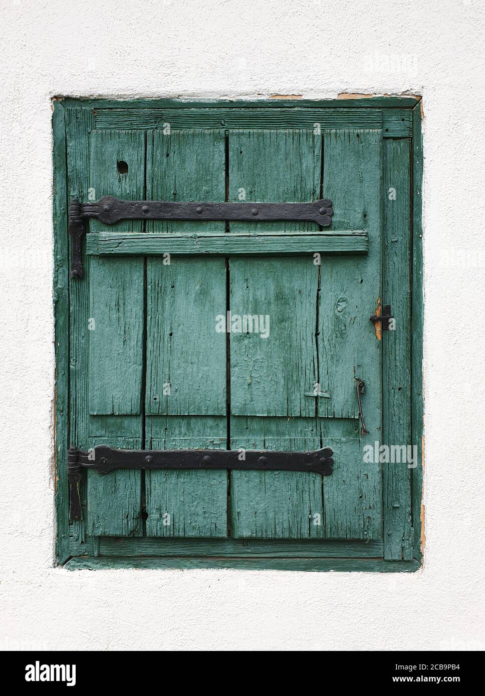 Closed wooden window shutters in Rimetea, Romania. Architecture detail of house window in the village of Rimetea, Torocko, Alba county, Romania Stock Photo