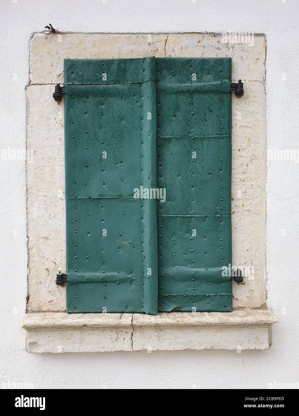 Closed metallic window shutters in Rimetea, Romania. Architecture detail of house window in the village of Rimetea, Torocko, Alba county, Romania Stock Photo