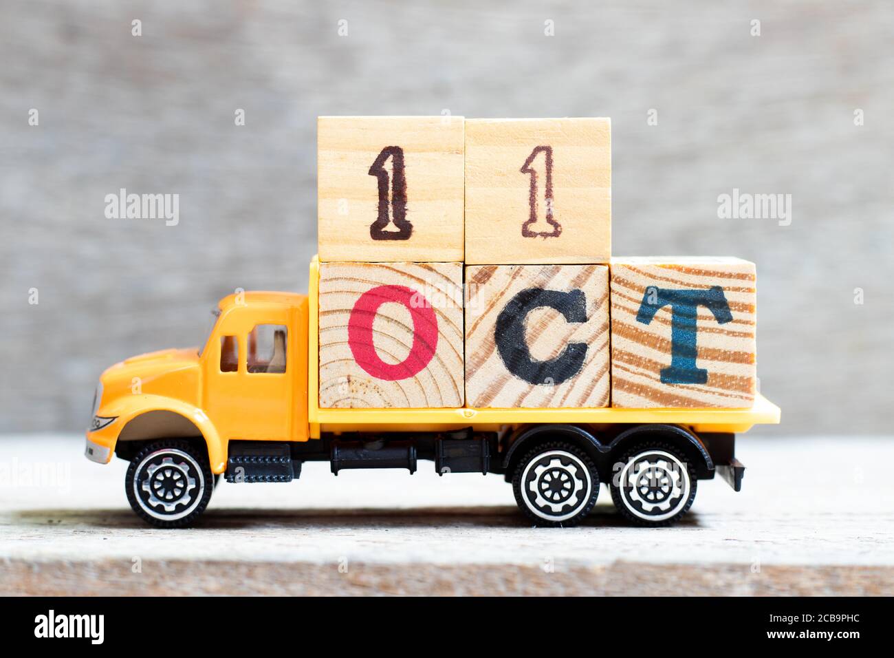 Truck hold letter block in word 11oct on wood background (Concept for date 11 month October) Stock Photo