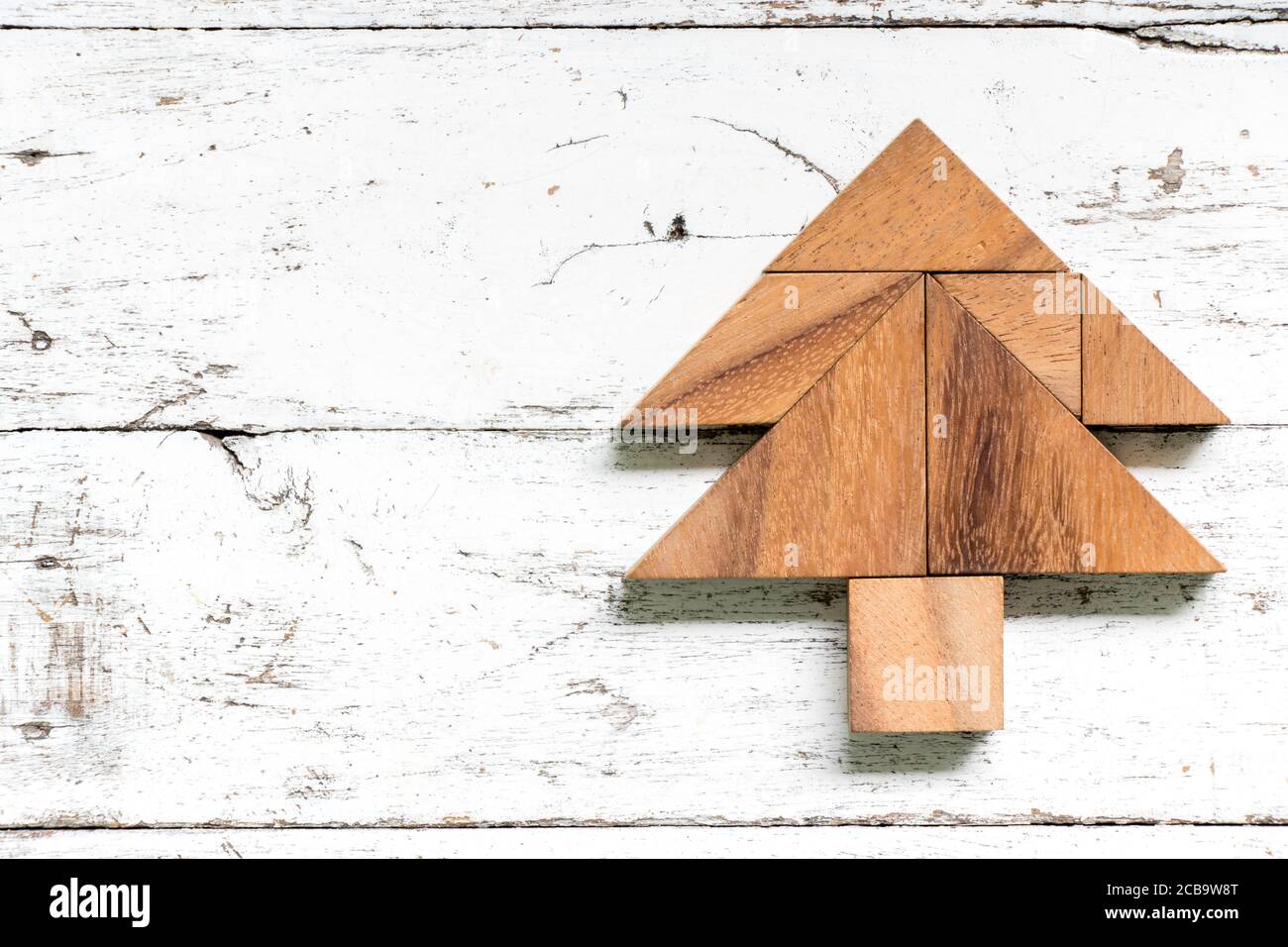 Tangram puzzle in pine or christmas tree shape on old white wood ...