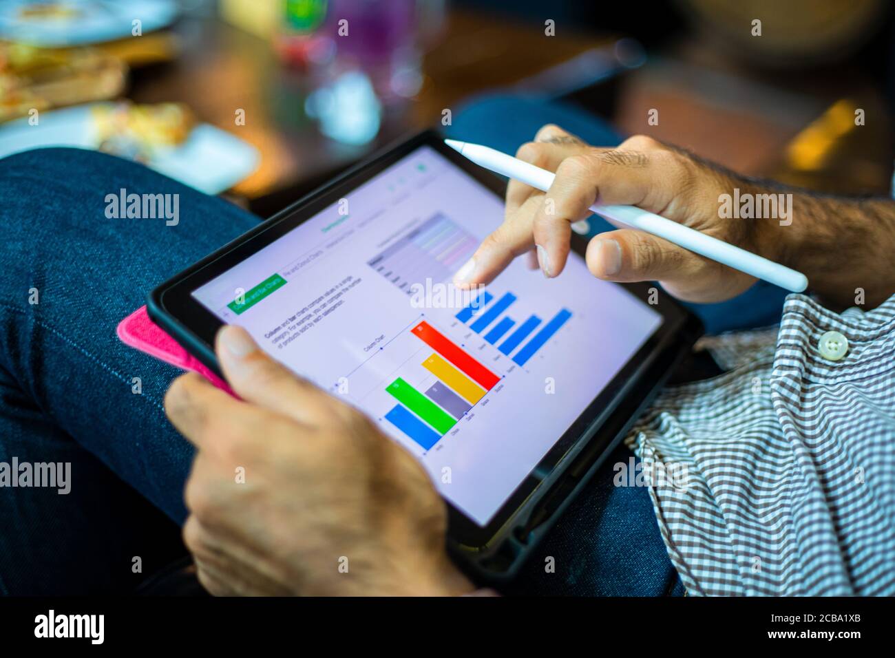 Asian business men using a tablet for working at coffee shop Stock Photo