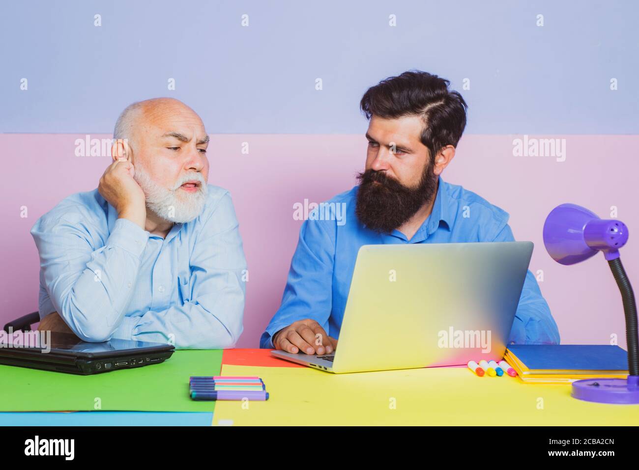 Old manager having friendly conversation at meeting with laptop ...