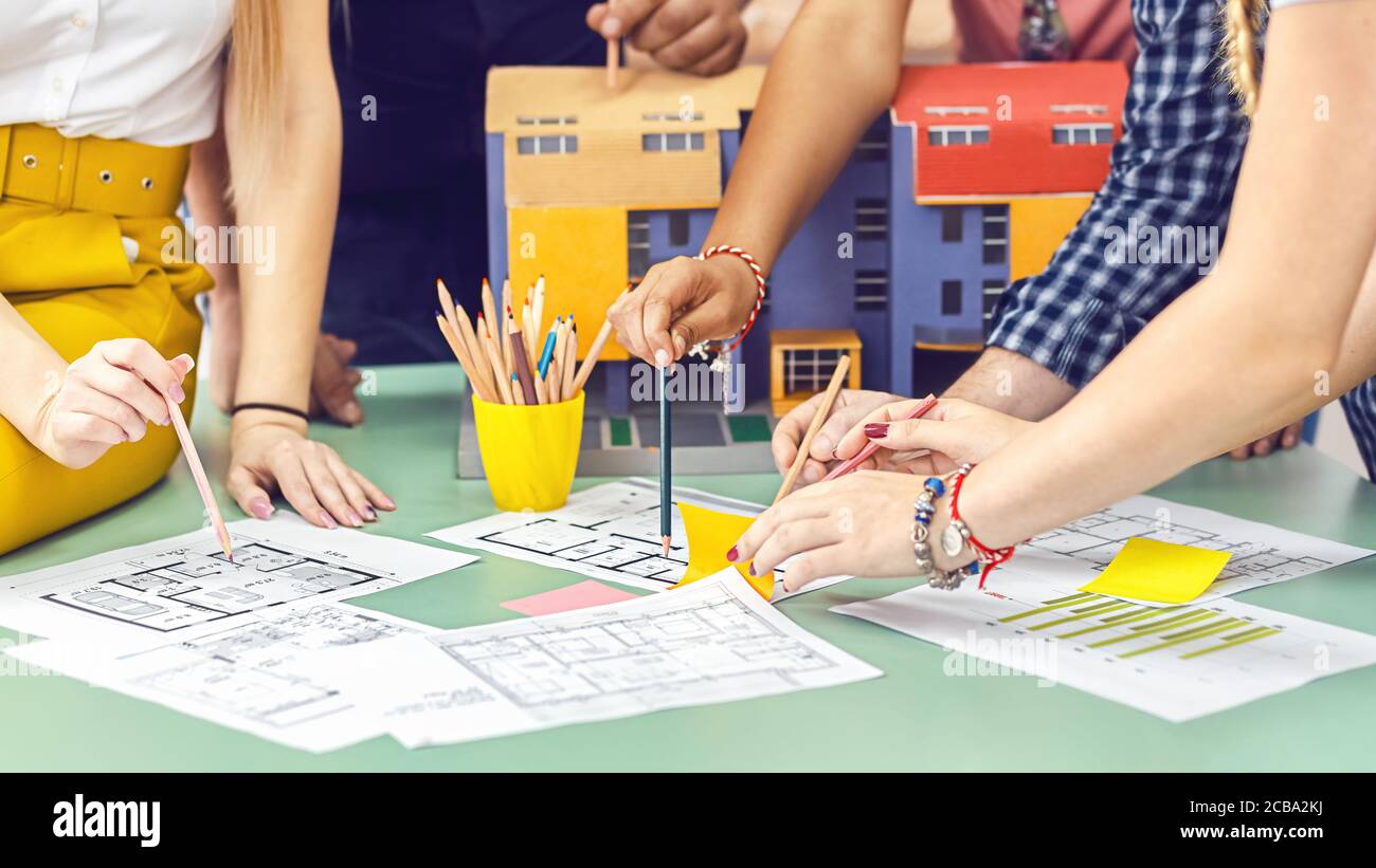 Creative architects team working on blueprint during brainstorm meeting Stock Photo