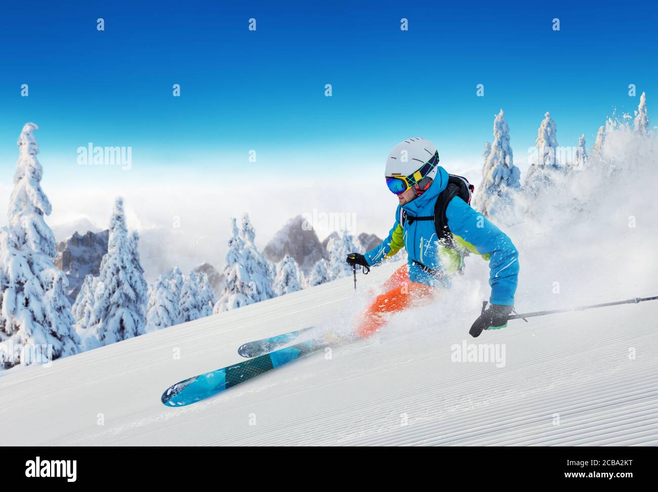 Young man skiing on piste. Winter sport and recreation in alpen mountain. Stock Photo