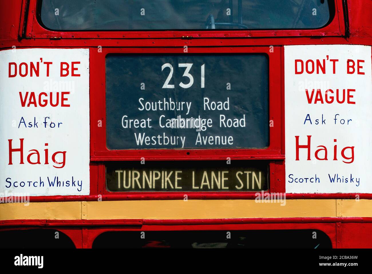 Woodcote, Oxfordshire, United Kingdom: ‘Don’t Be Vague Ask For Haig’, one of the most famous and long-running slogans in Scotch Whisky advertising, hand-painted on both top deck panels on the front of JXN 325, a preserved London Transport Routemaster (RT 935) double-decker bus on display at the 50th Anniversary Woodcote Steam and Vintage Transport Rally in July 2013.  The AEC Regent III bus, built in 1949 with Park Royal bodywork, was retired from service in the early 1960s and was bought for preservation in 1971.  It has since appeared regularly at classic and vintage vehicle rallies and show Stock Photo