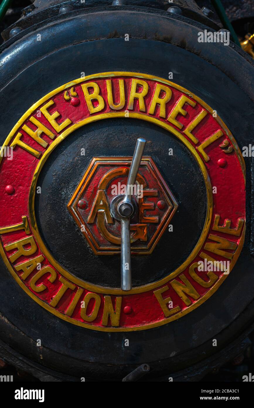 The Burrell manufacturer’s name gleams on the smoke box door of ‘Triumph’, Burrell No. 3917, 5 nhp (nominal horsepower) general purpose steam road locomotive TA 2374, at the 50th Anniversary Woodcote Steam & Vintage Transport Rally, in July 2013, at Woodcote, Oxfordshire, England, UK.  Triumph was built in 1921 at the Chas. Burrell & Sons works at Thetford, Norfolk.  It worked at Newton Poppleford, Devon, before being acquired for restoration and a new life touring steam rallies, shows and other events showcasing veteran and vintage vehicles. Stock Photo