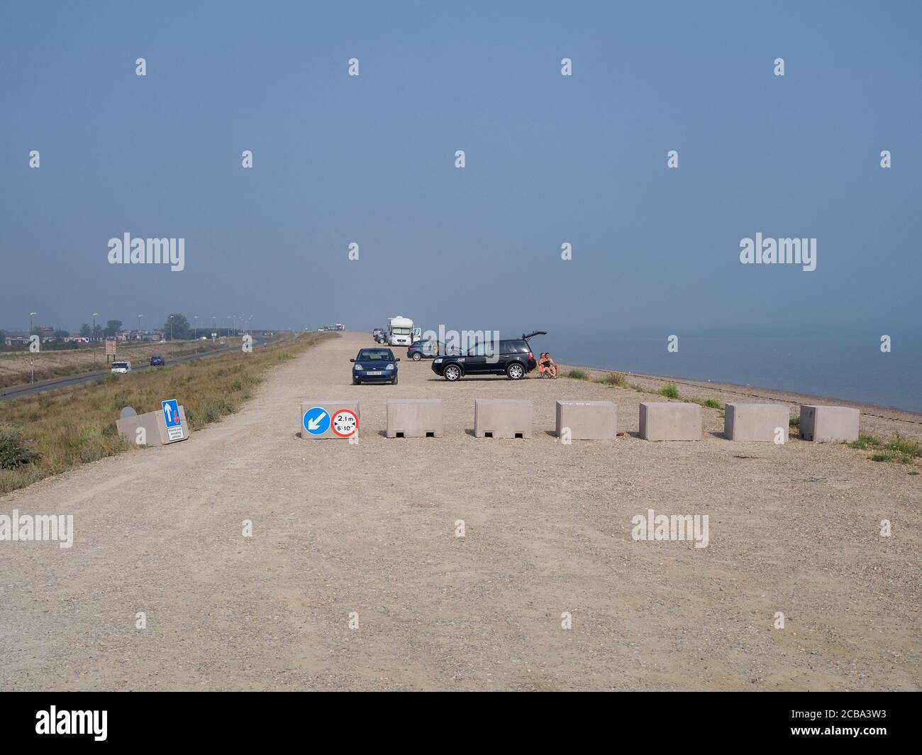 Minster on Sea, Kent, UK. 12th August, 2020. Swale Borough Council has installed a controversial parking restriction along the popular 'Shingle Bank' in Minster on Sea, Kent. Large concrete blocks have been installed to try to stop some motorists camping overnight for free. A petition has now been started to have them removed with many residents and visitors unhappy with the new development. Credit: James Bell/Alamy Live News Stock Photo