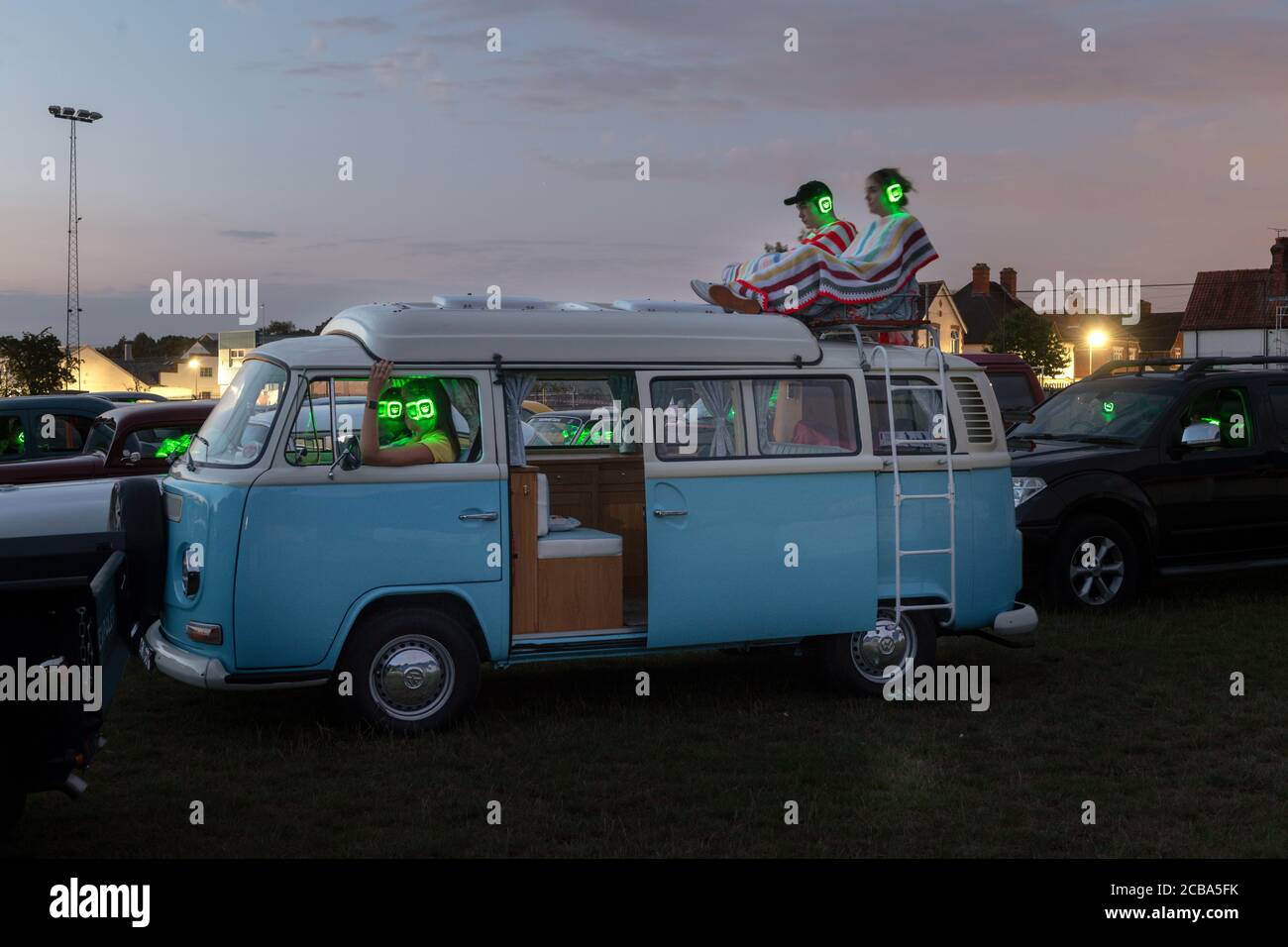 Watching a drive in move on a VW camper at night Stock Photo