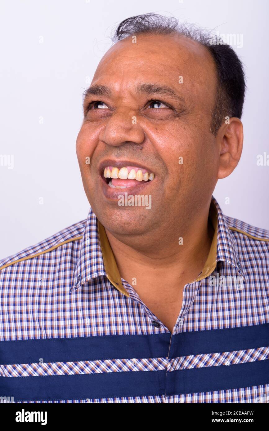 Portrait of happy mature overweight Indian businessman Stock Photo