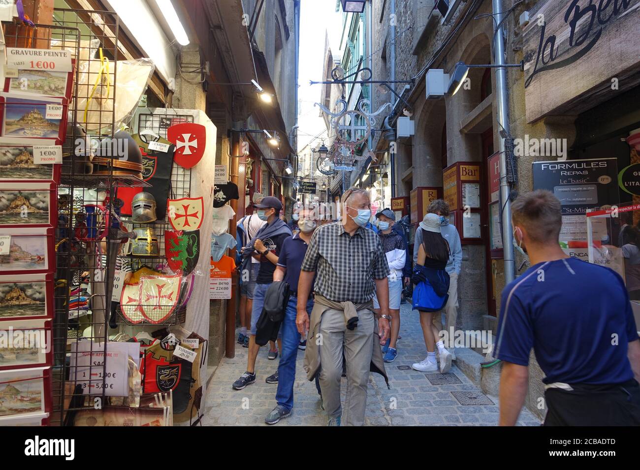 Mont St Michel, France July 2020: Tourists inside the walls of Mont St  Michel all have to wear masks even outside due to Coronavirus Pandemic  Stock Photo - Alamy, image size:1300x956