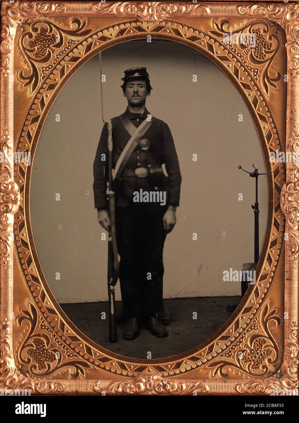 [Union Soldier Holding Rifle, with Photographer's Posing Stand], 1861