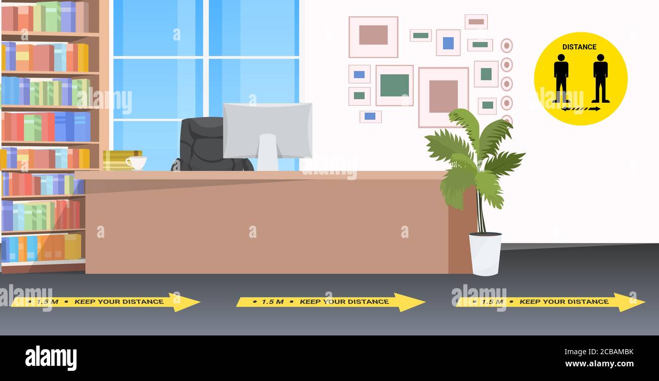 empty no people reception desk with signs for social distancing yellow