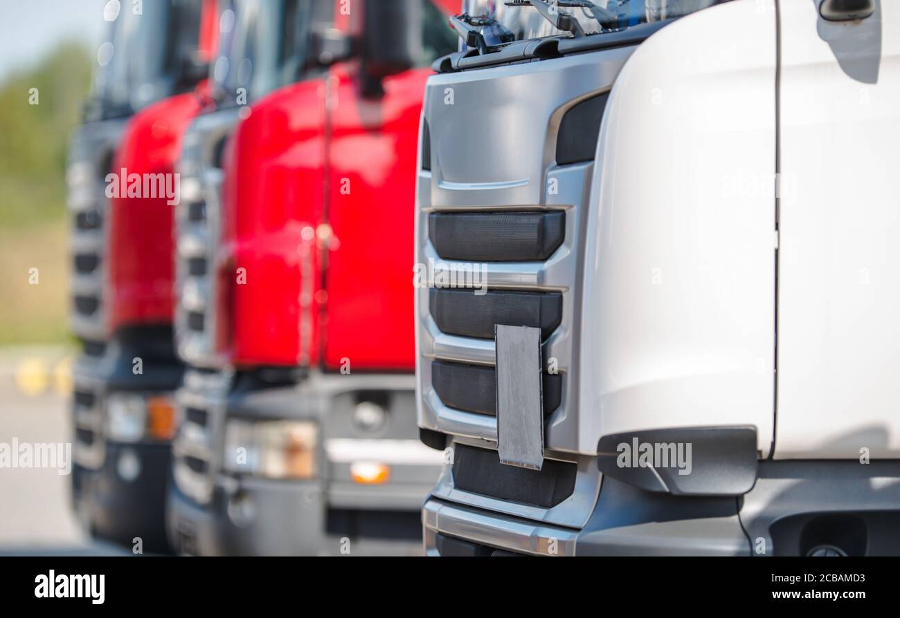 Transportation and Automotive Industry. Pre Owned Semi Truck Tractors in a Row. Dealership Lot. Trucking Theme. Stock Photo