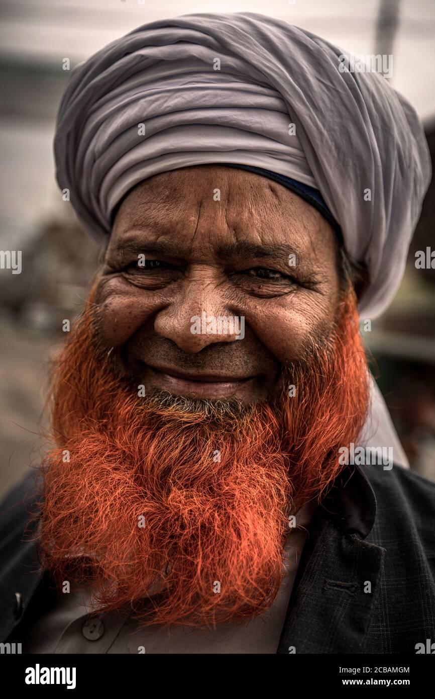 Older muslim man with henna dyed beard before Important sikh temple Gurudwara Janam Asthan Nankana Sahib the birthplace of Guru Nanak Sahib Ji Pakistan. Stock Photo
