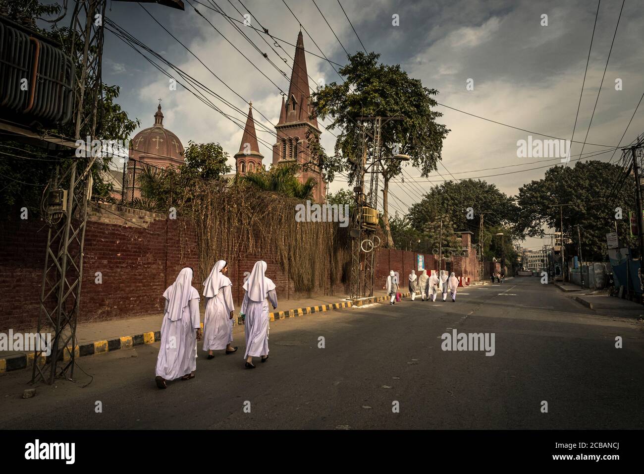 Nuns on their way to Sunday service in the Sacred Heart Cathedral in Lahore in Pakistan. For safety reasons and impending attacks, the roads in the area are closed. Stock Photo