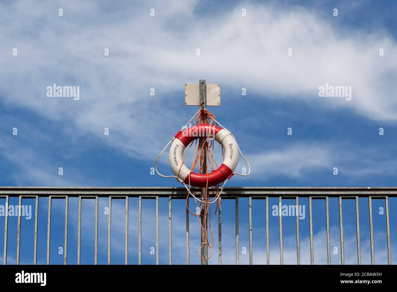 Lifebuoy on the railing of a bridge over a river Stock Photo