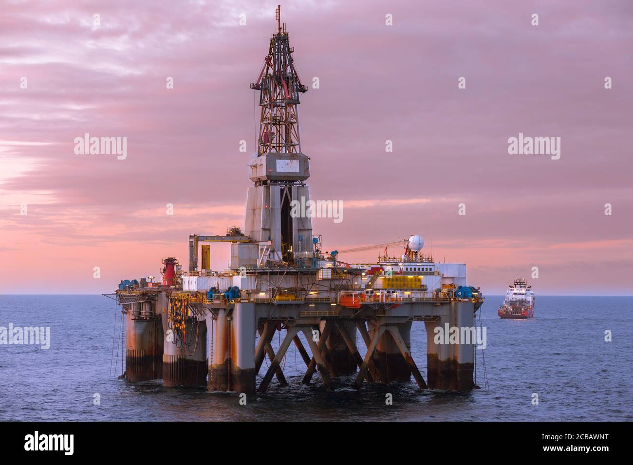 NORTH SEA, NORWAY - 2015 MAY. Beautiful sunset at offshore at oil rig Transocean Prospect and offshore vessel KL Sandefjord in North Sea. Stock Photo