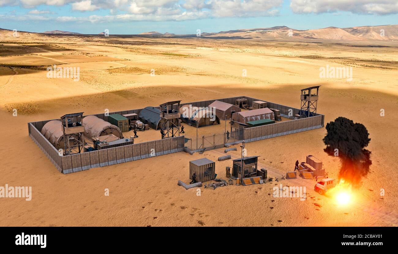 Military compound in the middle east, aerial view of a military base. Kamikaze attack. Explosion of a vehicle. Guard towers and reinforced fence Stock Photo