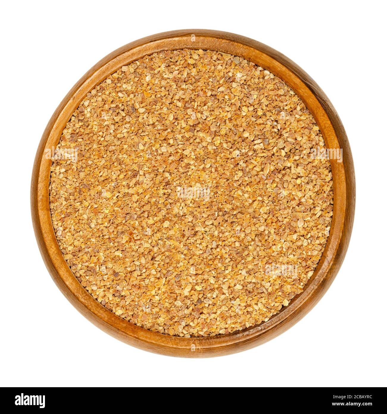 Dried grated lemon peel in a wooden bowl. Dry zests of ripe yellow edible citrus fruits. Citrus limon. Used as flavoring for baking and cooking. Stock Photo
