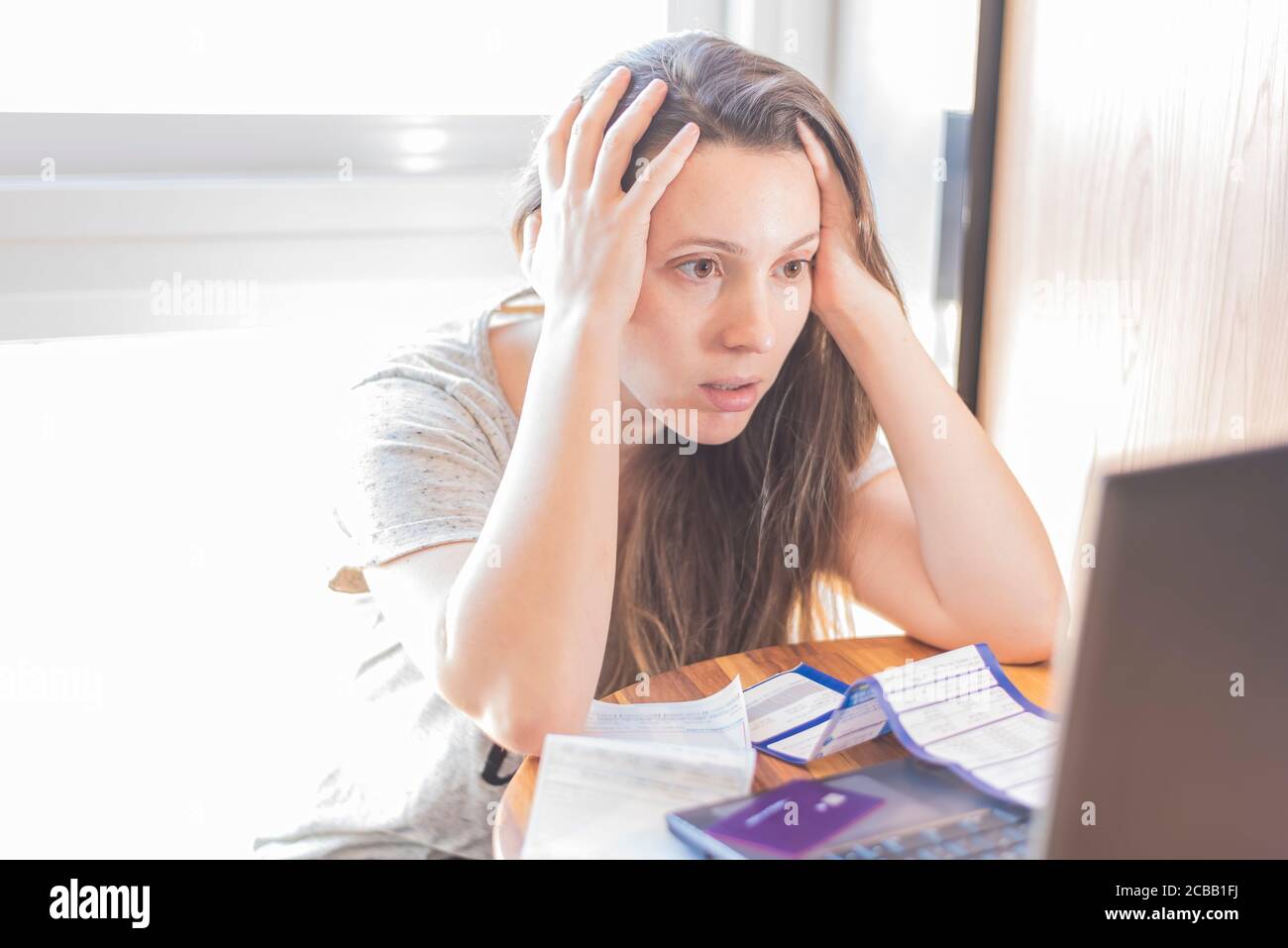 Desperate woman with bills and debts to pay Stock Photo