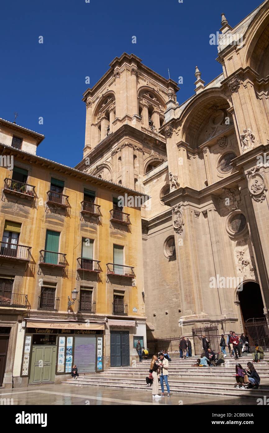 A building on the Plaza de los Pasiegas with the tower of Granada Cathedral in the background. Granada, Andalusia, Spain. Stock Photo