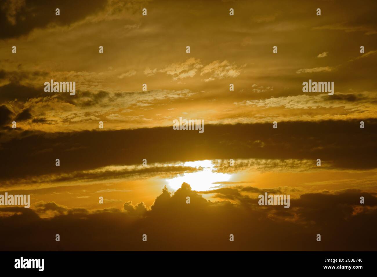 Abstract pattern of yellow brown clouds formed during a dramatic sunset Stock Photo