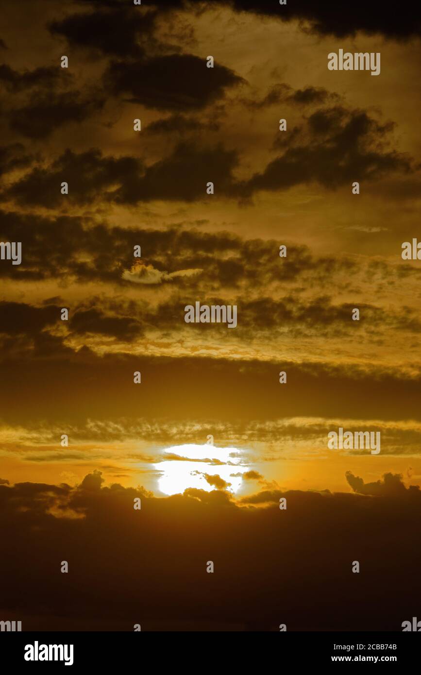 Abstract pattern of yellow brown clouds formed during a dramatic sunset Stock Photo