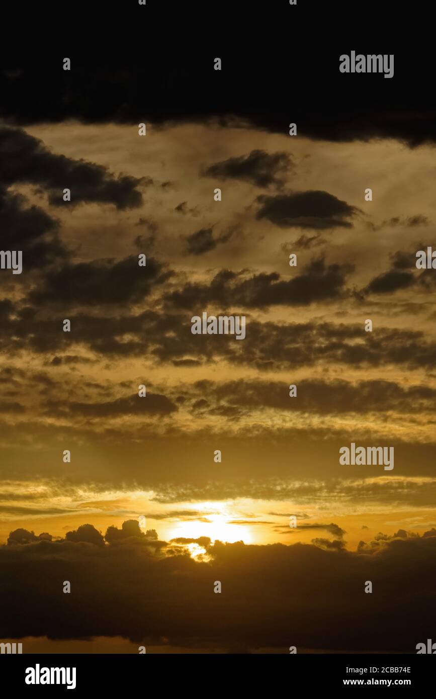Abstract pattern of yellow brown clouds formed during a dramatic sunset Stock Photo