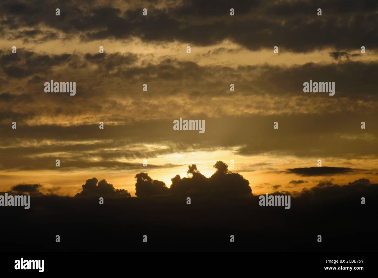 Abstract pattern of yellow brown clouds formed during a dramatic sunset Stock Photo