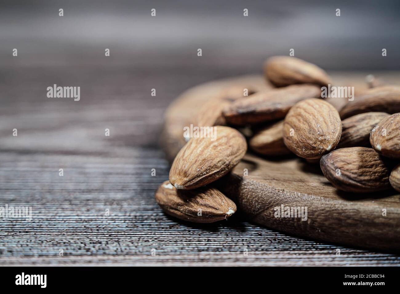Close up of cashew nuts isolated on a wooden background. Stock Photo