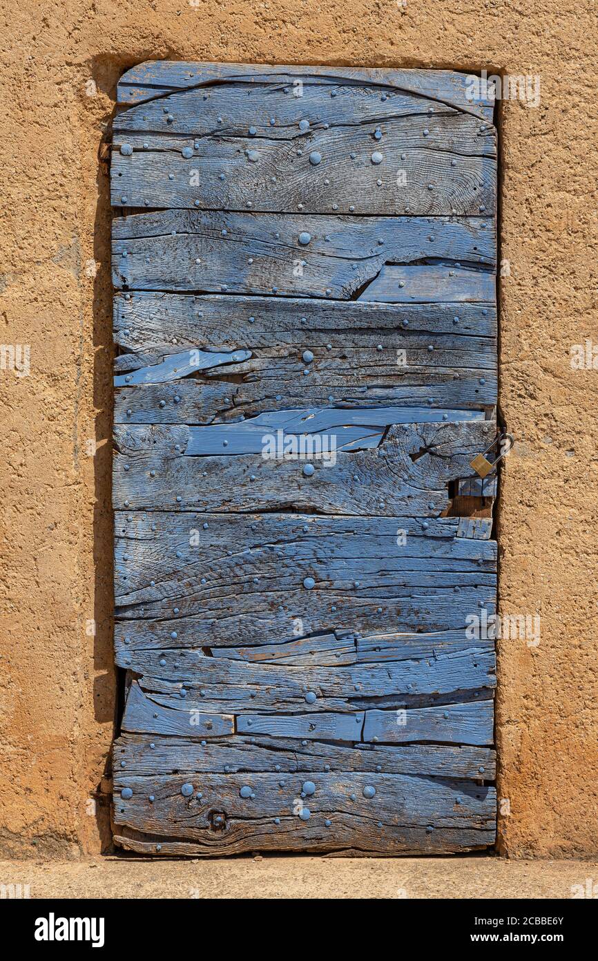 An old blue painted wooden door in the village of Roussillon Stock Photo