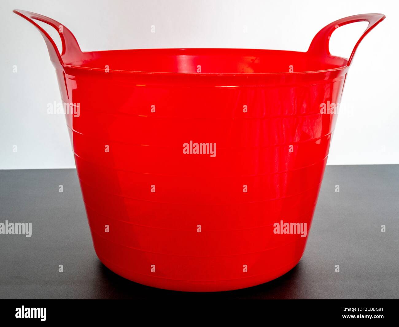 Bright red, flexible rubber, gardening trug / tub, with a handle each