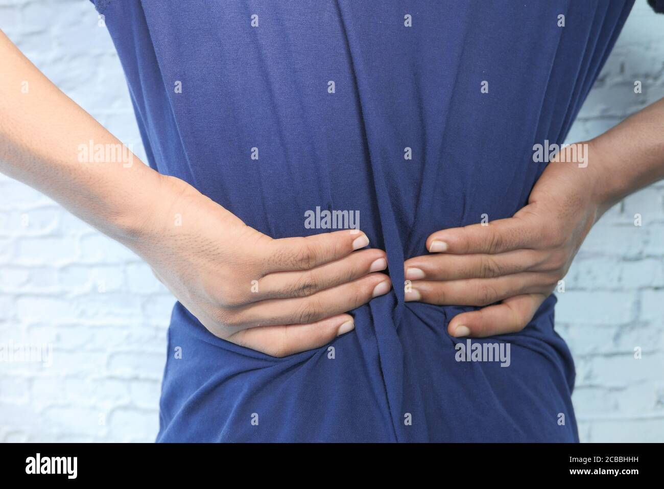 young man suffering back pain close up Stock Photo