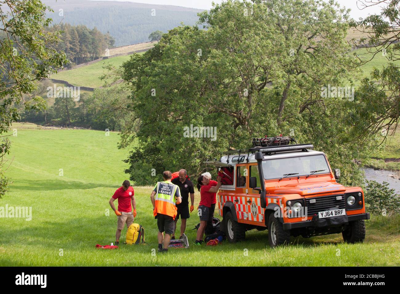 Yorkshire, UK, 12 August 2020: An ambulance crew and a Mountain Rescue team was called out to incident near Appletreewick, where a woman had a suspected broken ankle and had to be stretchered out. Dozens of holiday makers and locals took advantage of the 28 degree heat to swim in the river Wharfe in the Yorkshire Dales National Park. Anna Watson/Alamy Live News Stock Photo