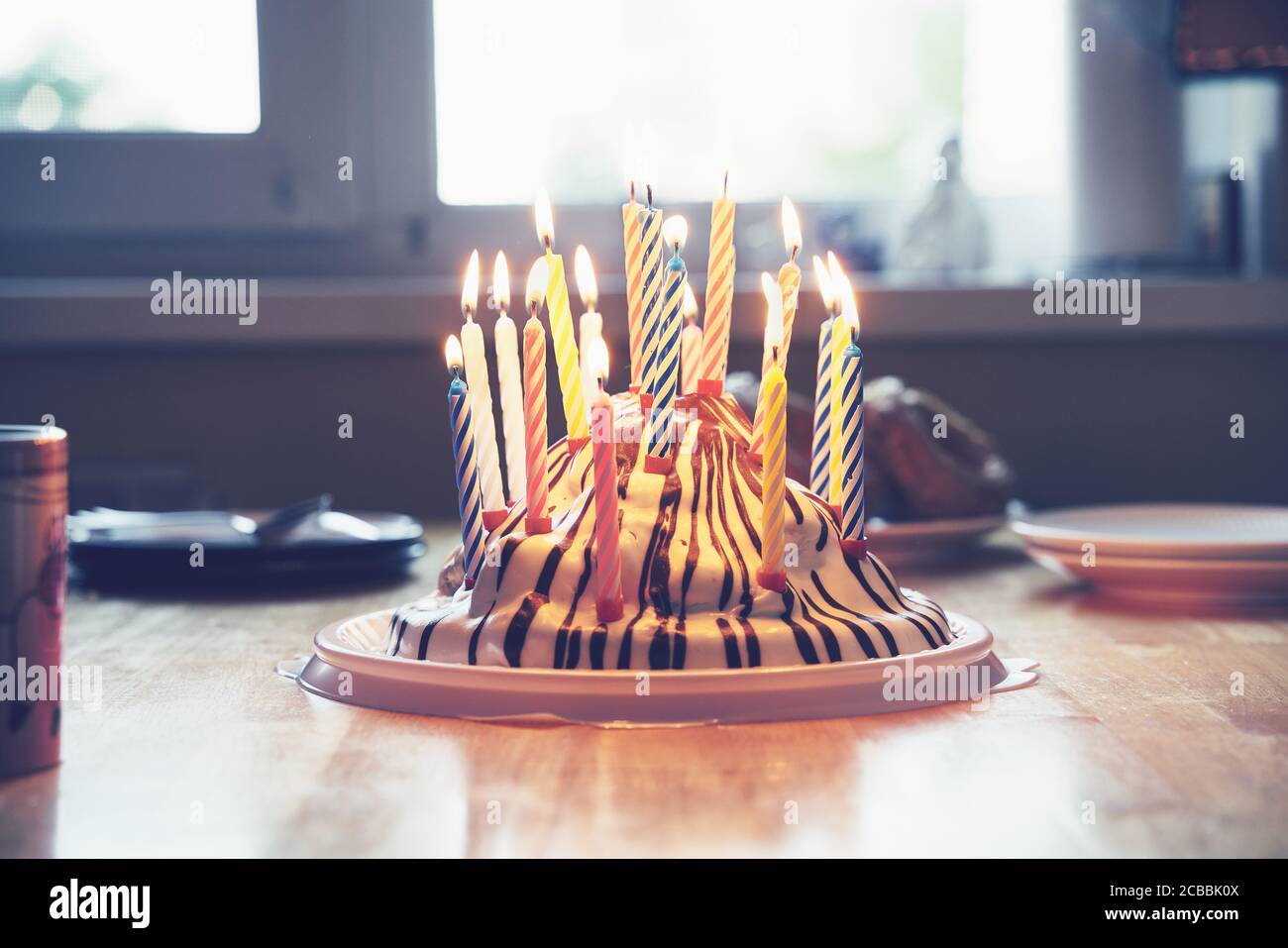 Colorful birthday cake with nineteen candles on table childlike home party Stock Photo