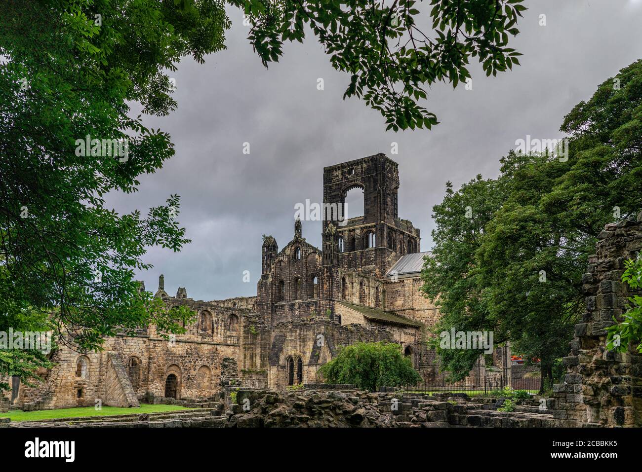 Kirkstall Abbey in Leeds, old ruined abbey surrounded by trees and green countryside in West Yorkshire Stock Photo