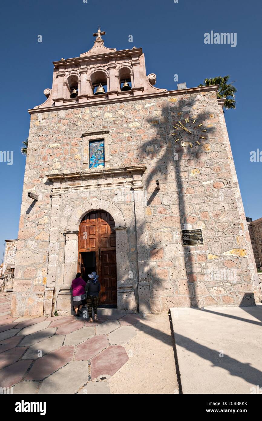 Pilgrims enter the chapel where Saint Toribio Romo was the parish priest in Santa Ana de Guadalupe, Jalisco State, Mexico. Father Toribio was a Mexican Catholic priest and martyr who was killed during the anti-clerical persecutions of the Cristero War. Stock Photo
