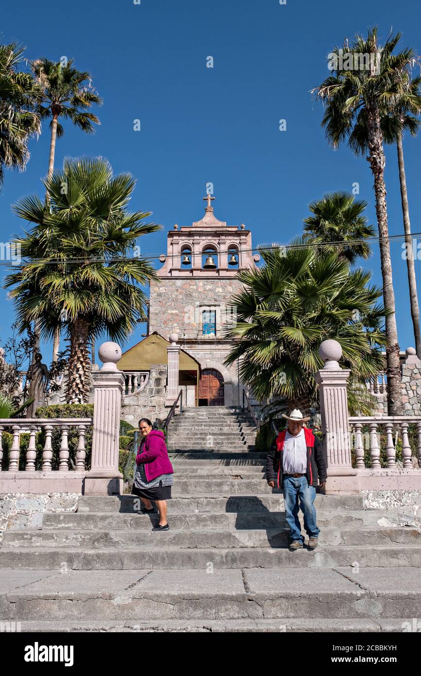 Pilgrims depart the chapel where Saint Toribio Romo was the parish priest in Santa Ana de Guadalupe, Jalisco State, Mexico. Father Toribio was a Mexican Catholic priest and martyr who was killed during the anti-clerical persecutions of the Cristero War. Stock Photo