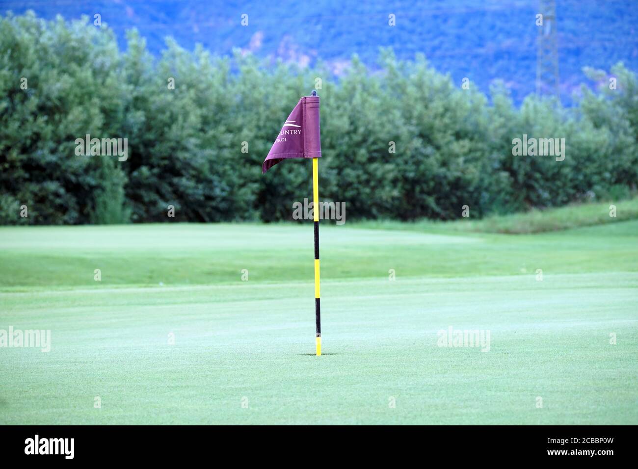 Flag on the green of the Blue Monster golf course in South Tirol, Italy. Stock Photo