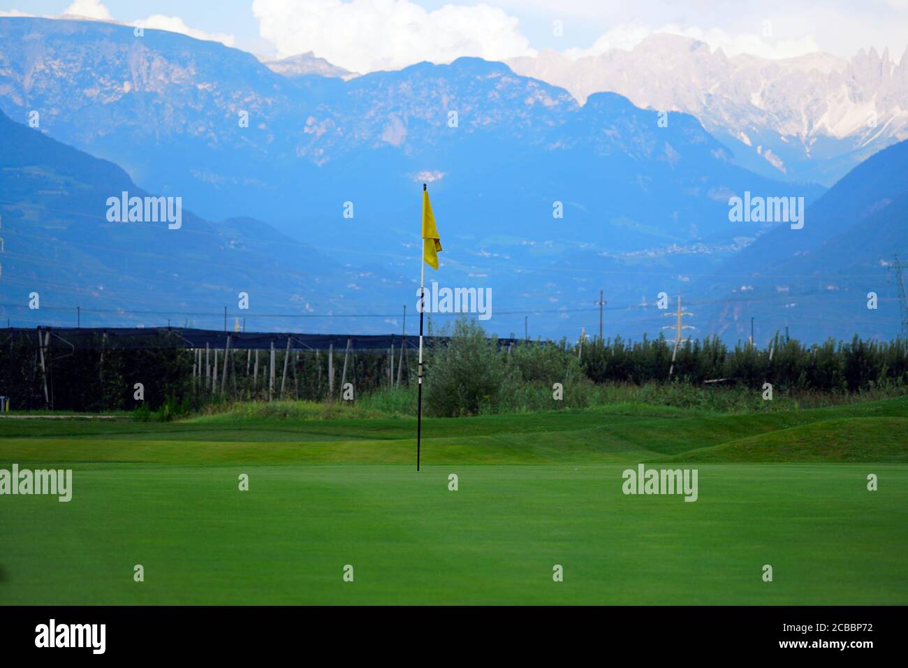 Flag on the green of the Blue Monster golf course in South Tirol, Italy. Stock Photo