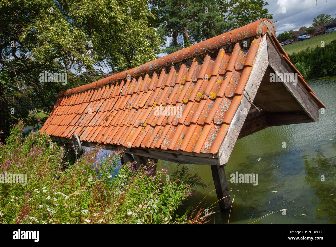 Old wooden, boat house, clay tiled roof, fishpond in the grounds