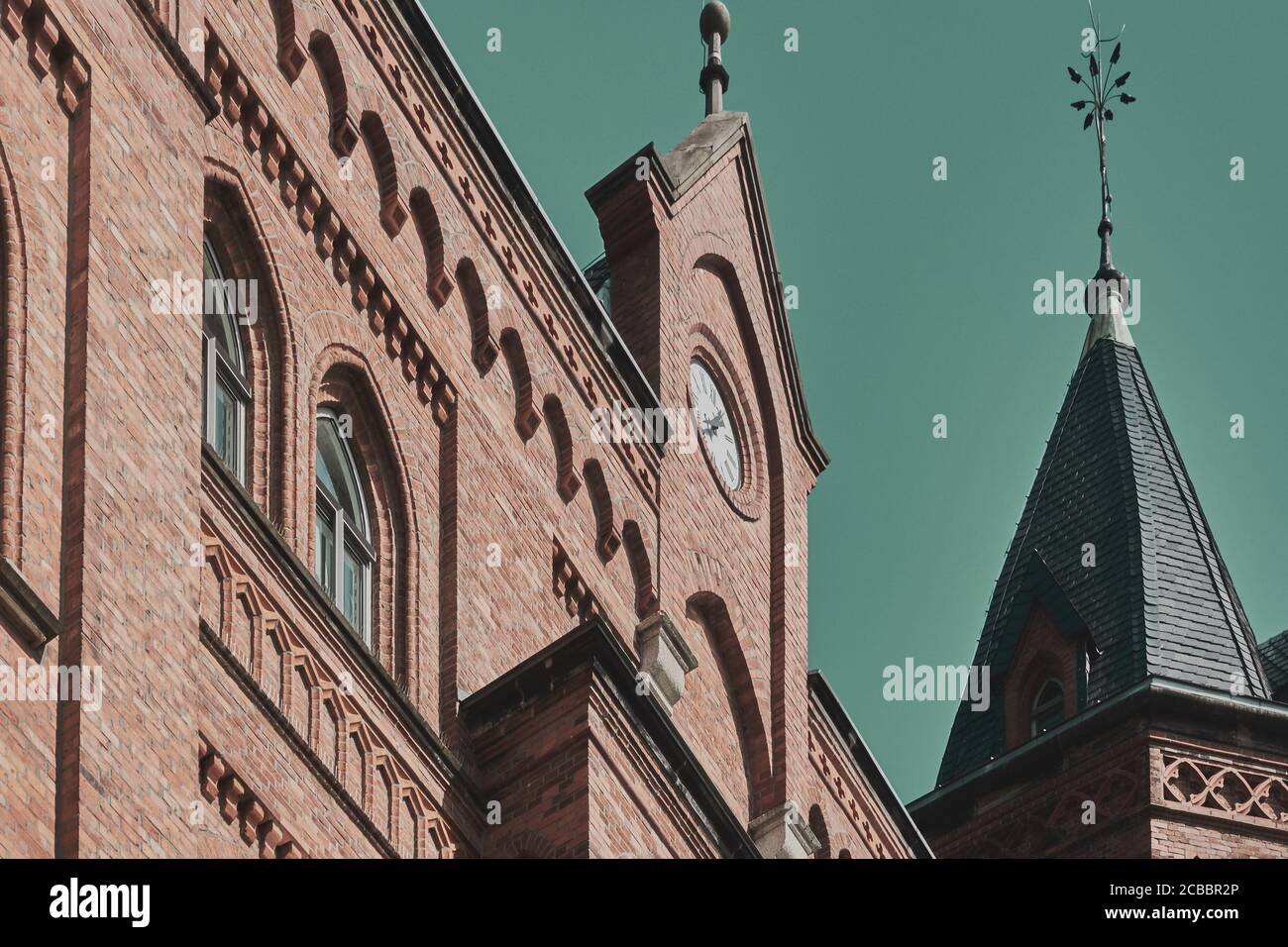Old building with decorated brick masonry in a German old town, with a tower with slate roof Stock Photo