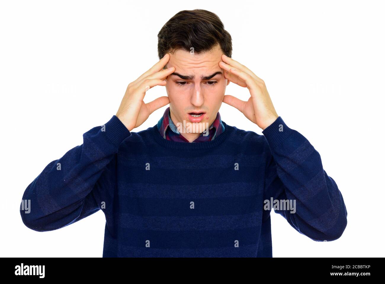 Studio shot of young handsome Caucasian man looking shocked and surprised isolated against white background Stock Photo