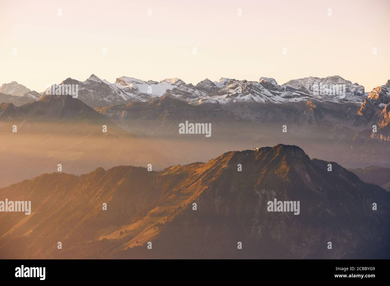 Panorama of snowcapped mountain range at beautiful sunrise. View from Mount Pilatus, Lucerne, Switzerland. Stock Photo
