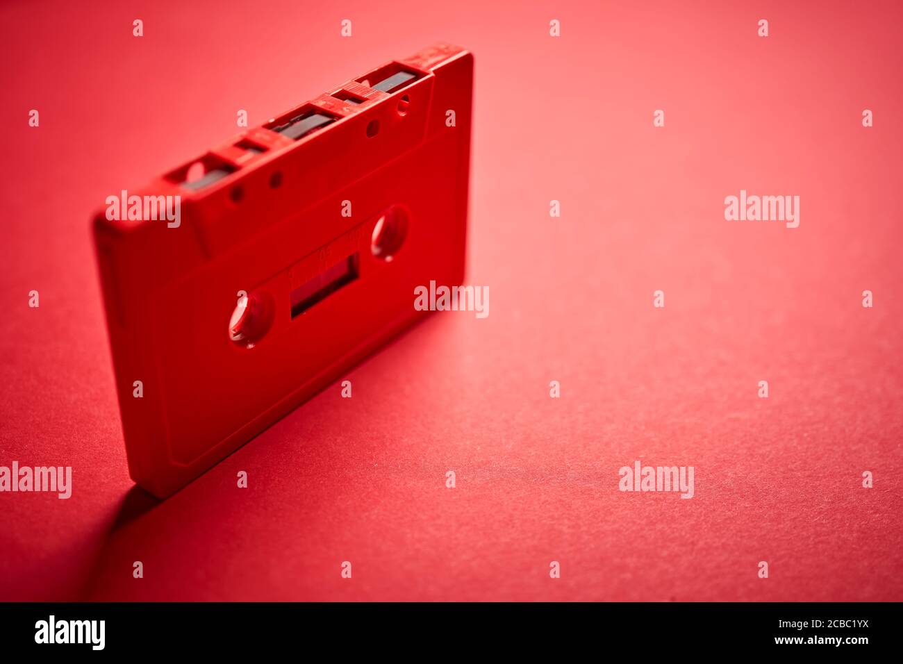 old red cassette tape on a minimalist background Stock Photo - Alamy