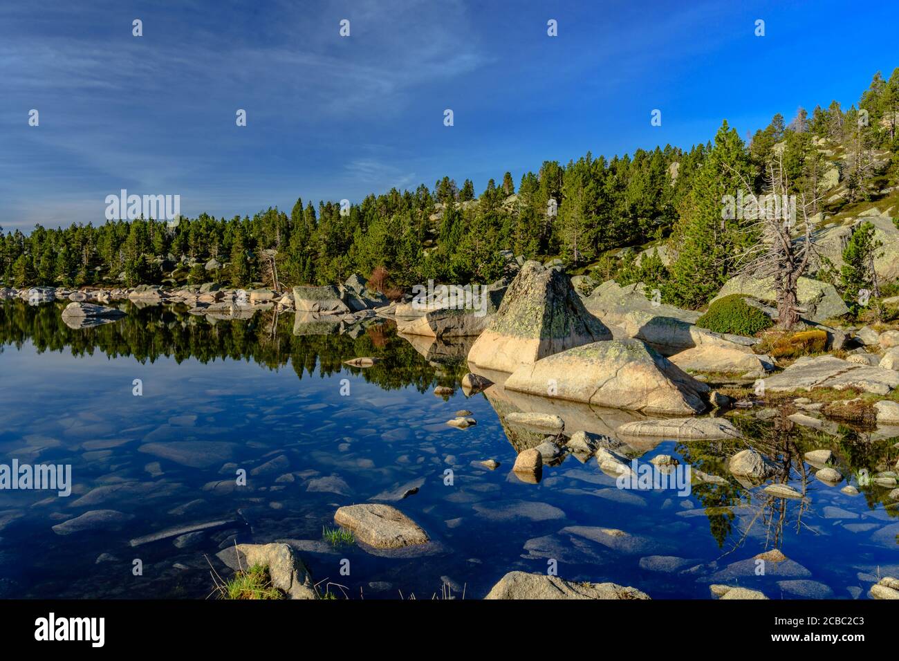 Morning reflexions in the mountain lake Stock Photo