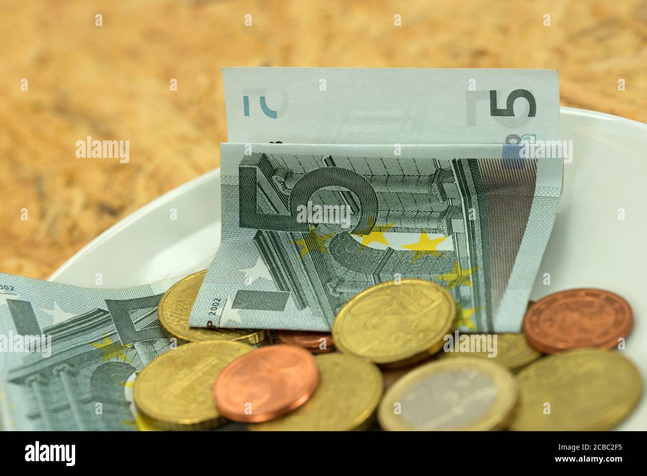 Small money on a plate Stock Photo