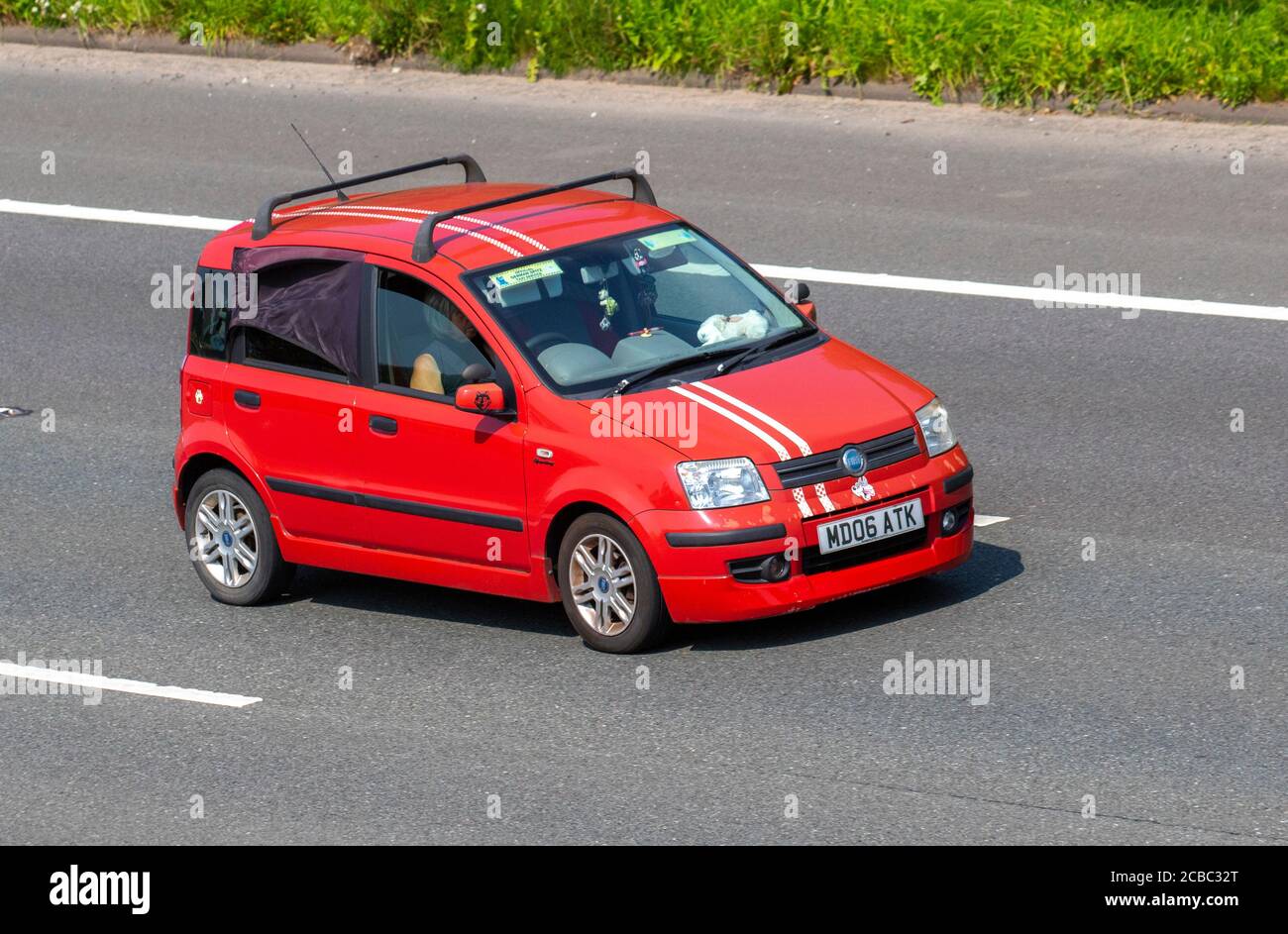 2006 red Fiat Panda Dynamic Multijet all-wheel drive, five passenger city car; Vehicular traffic moving vehicles, moving cars driving vehicle on UK roads, motors, motoring on the M6 motorway highway network. Stock Photo